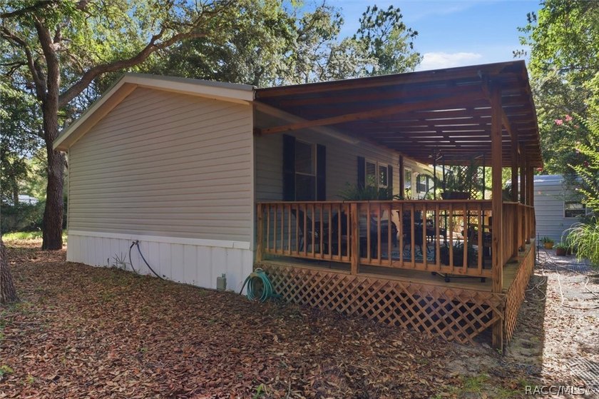 Framed by a canopy of mature trees and lush landscaping, this - photo 29