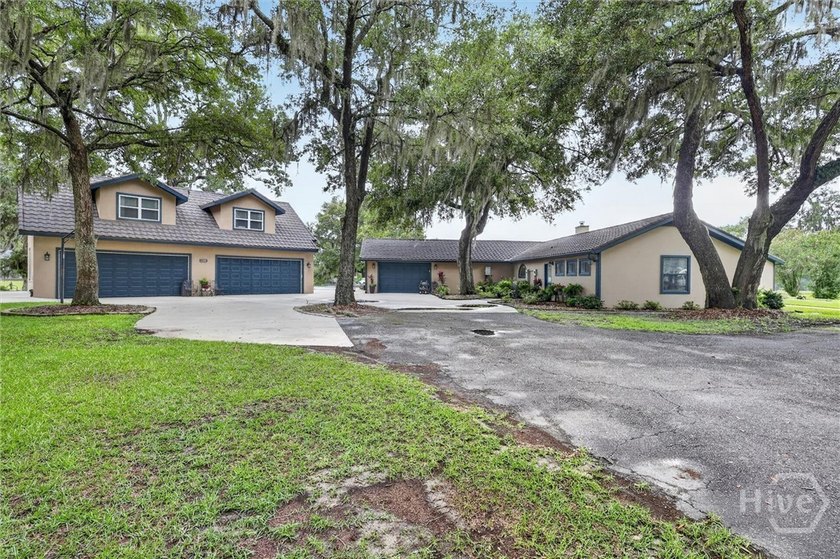 Nestled beneath 22 mature oak trees and surrounded by coastal - photo 4