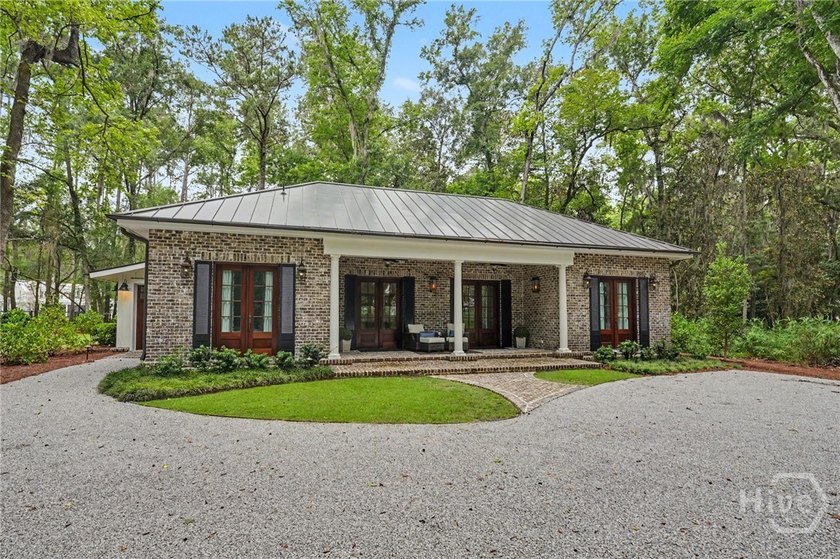 Tucked beneath a canopy of majestic live oaks draped in Spanish - photo 2