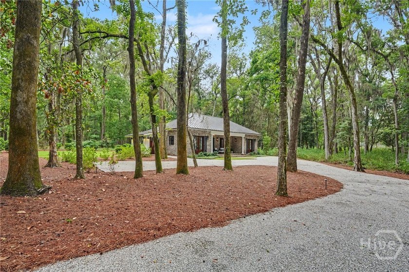 Tucked beneath a canopy of majestic live oaks draped in Spanish - photo 3