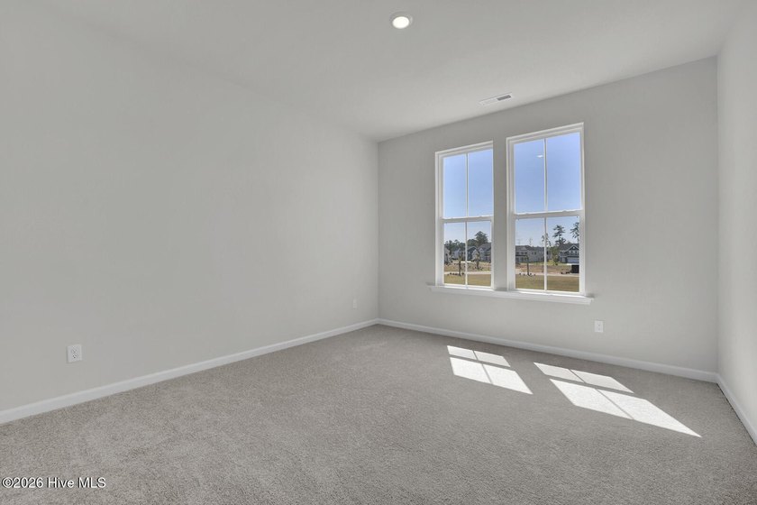 This spacious townhome boasts a first-floor primary suite, and - photo 22