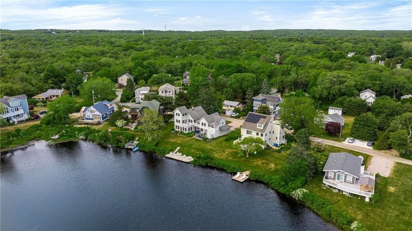 Perched at the water's edge, 19 Teal Drive is a custom-built - photo 12