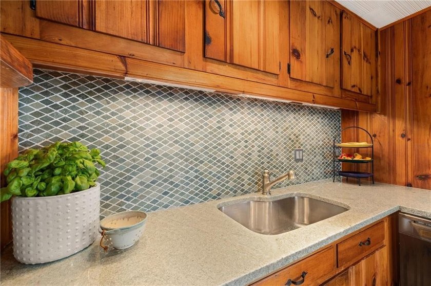 Perched at the water's edge, 19 Teal Drive is a custom-built - photo 23