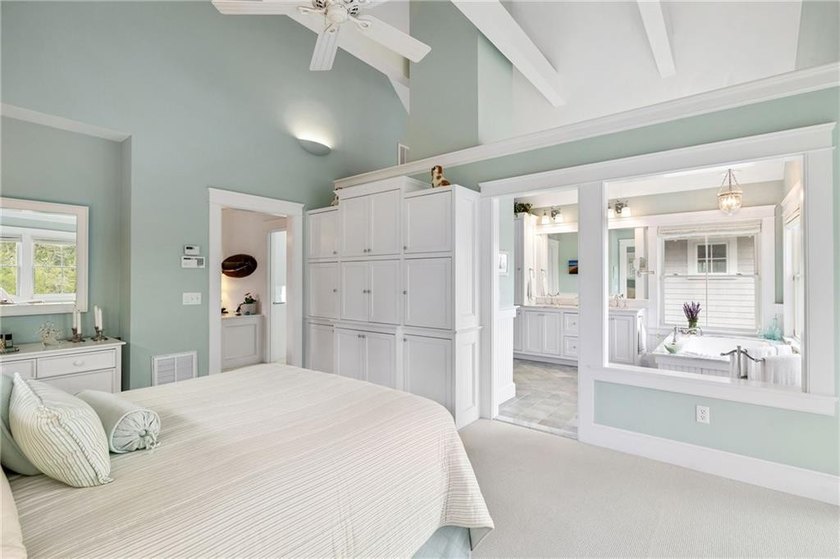 Perched at the water's edge, 19 Teal Drive is a custom-built - photo 32