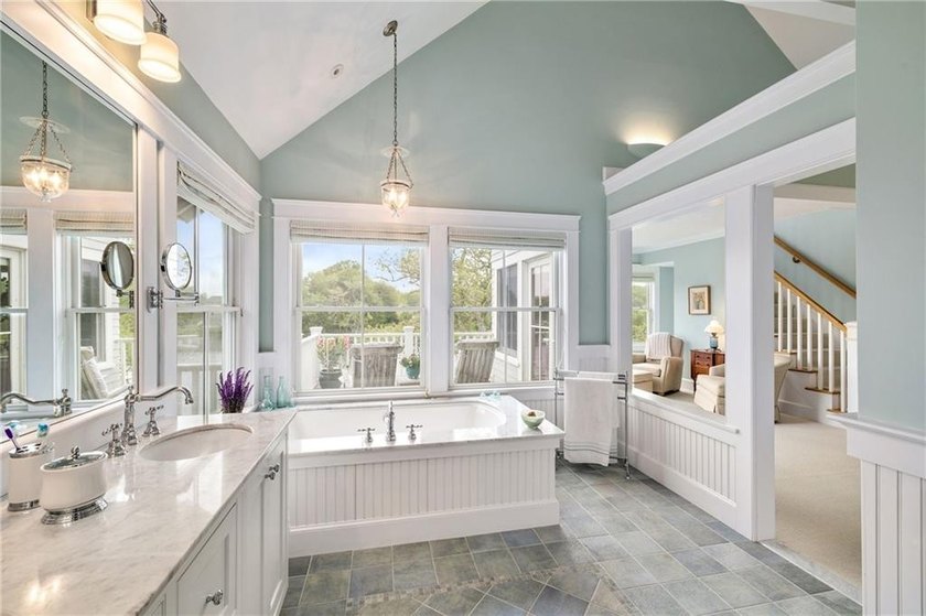 Perched at the water's edge, 19 Teal Drive is a custom-built - photo 34