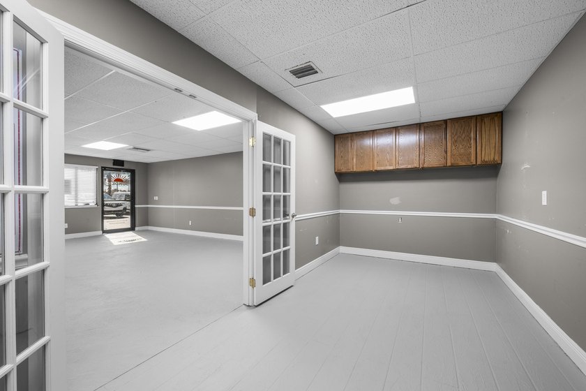 Bright, open showroom with newly applied SunDek finished floors - photo 8