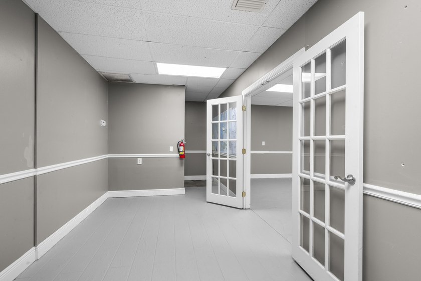 Bright, open showroom with newly applied SunDek finished floors - photo 9