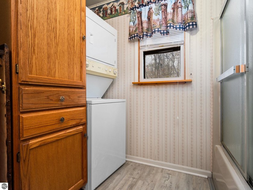 Tucked away on 8+ wooded acres along the Manistee River and - photo 22