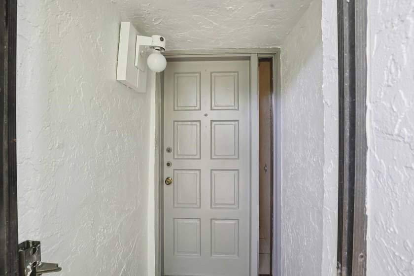 Discover a rare corner-unit retreat in a secure, gated community - photo 4