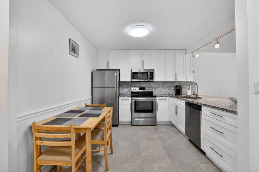 Fully updated 2/2 with 1-car garage! Features an open kitchen - photo 6