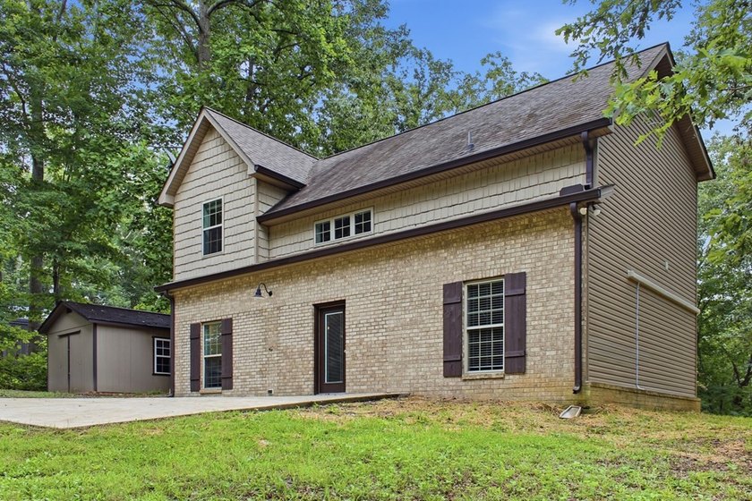 Tucked into a private, wooded setting just minutes from Center - photo 12