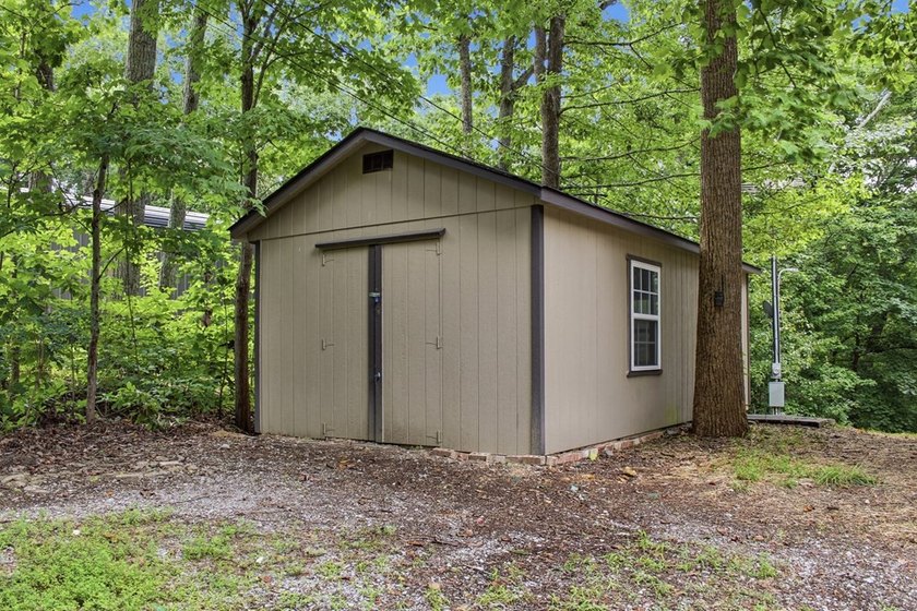 Tucked into a private, wooded setting just minutes from Center - photo 17