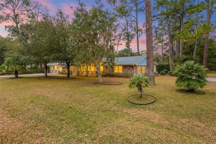 Set beneath a quiet canopy of live oaks, 636 Old Plantation Road - photo 3