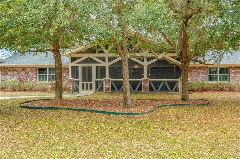 Set beneath a quiet canopy of live oaks, 636 Old Plantation Road - photo 4