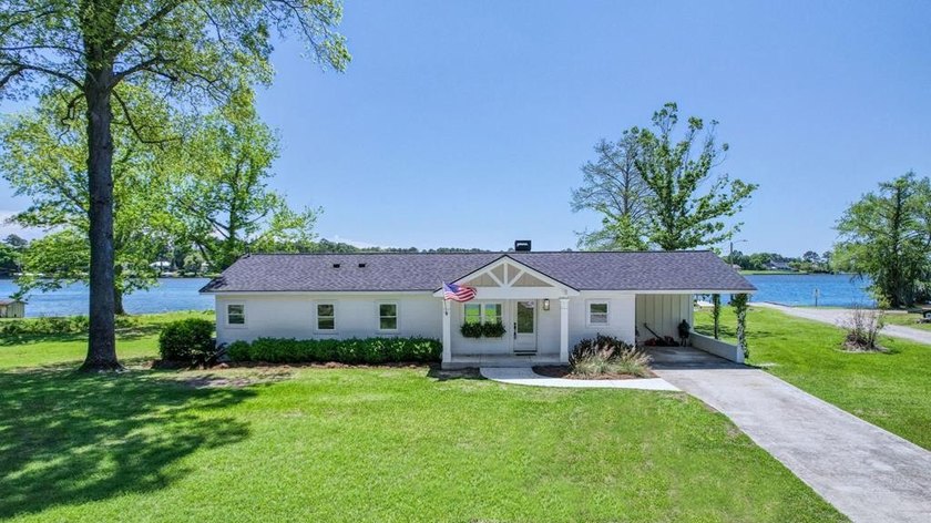 This Lake Home is truly a rare gem! Nestled along 165 Feet of - photo 2