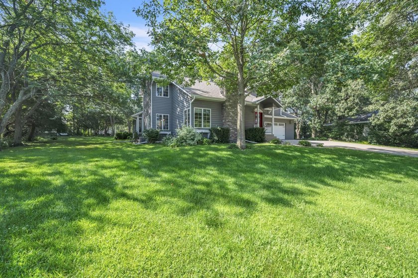 Just off East Okoboji Lake, nestled in the trees sits a - photo 2