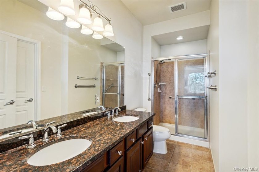 Welcome to this highly sought-after first-floor end unit located - photo 17