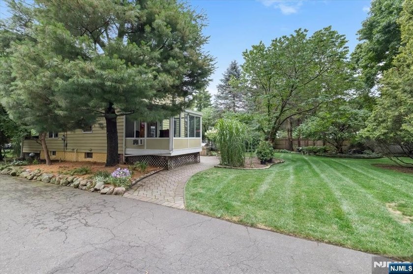 This home is gracefully positioned on a beautifully landscaped - photo 43