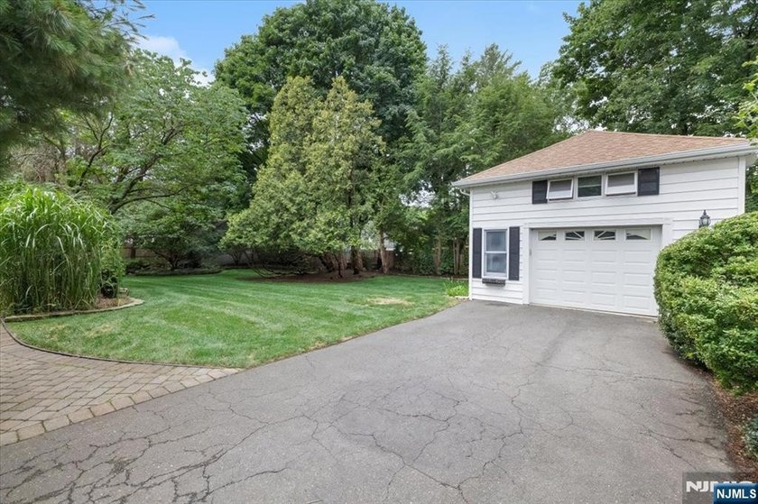 This home is gracefully positioned on a beautifully landscaped - photo 44