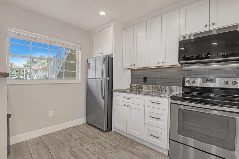 Welcome to this beautifully updated, light-filled corner unit - photo 6