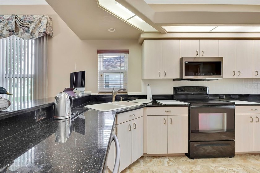 Set within the gated Glen Lakes Golf &amp; Country Club, this 2,238 - photo 13