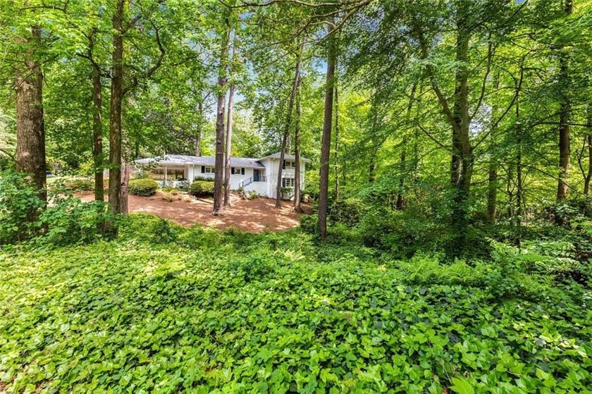 Nestled on a large + acre serene, corner lot in the highly - photo 3