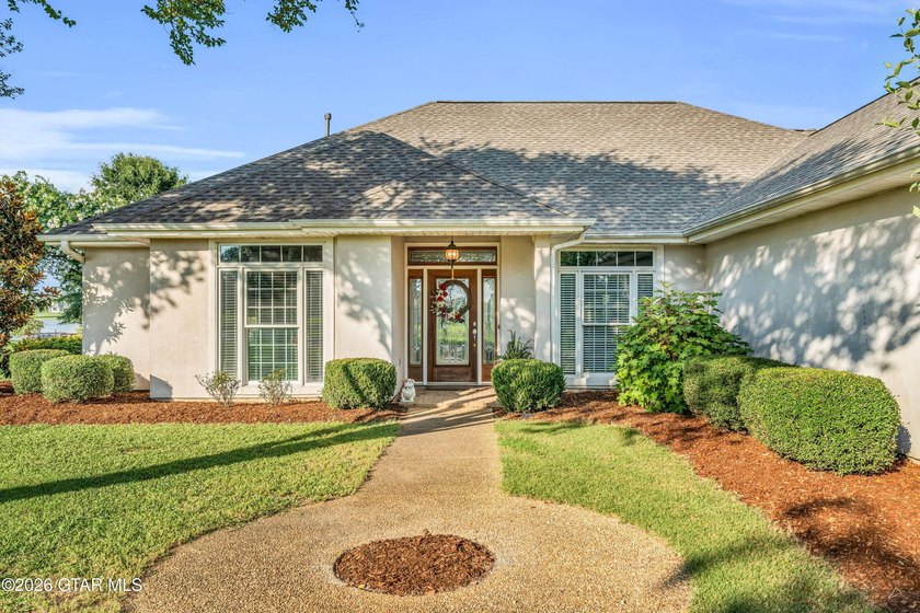 Nestled on approximately 1.5 beautifully landscaped acres in the - photo 2