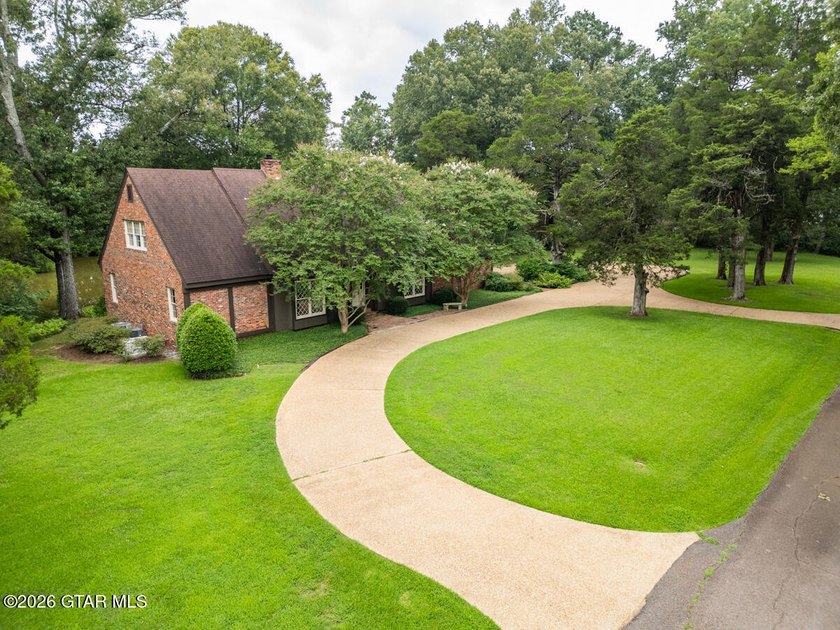 Set on 4.04 acres with pond frontage, this custom-built - photo 2