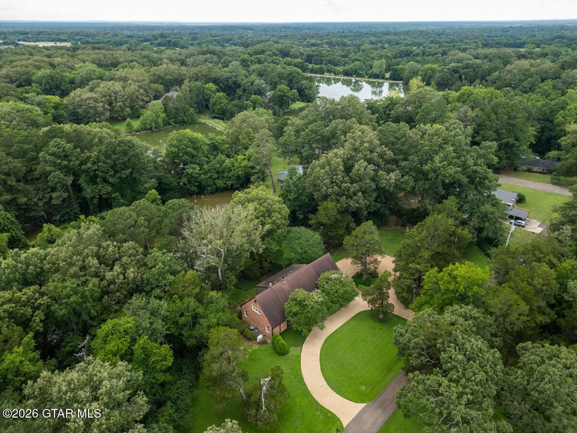 Set on 4.04 acres with pond frontage, this custom-built - photo 3