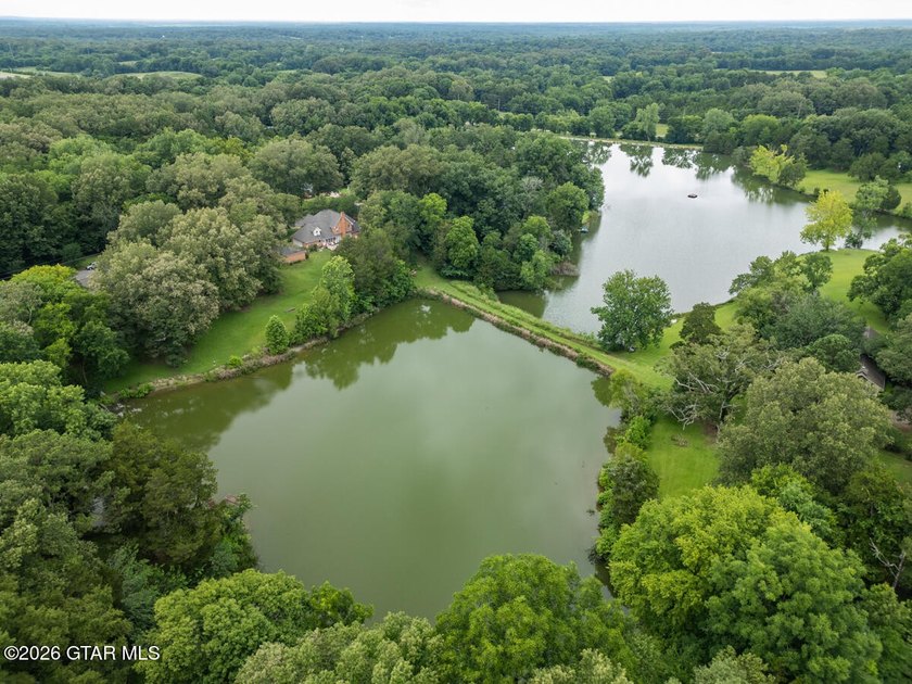 Set on 4.04 acres with pond frontage, this custom-built - photo 5