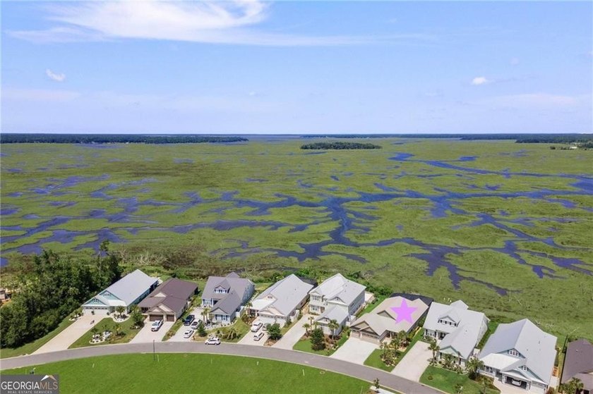 Welcome to a refined coastal sanctuary in the gated enclave of - photo 3