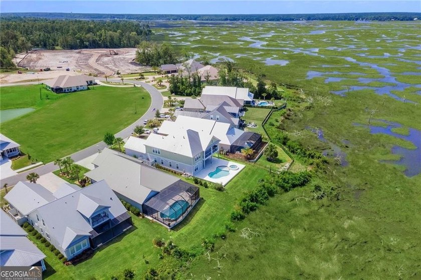 Welcome to a refined coastal sanctuary in the gated enclave of - photo 4