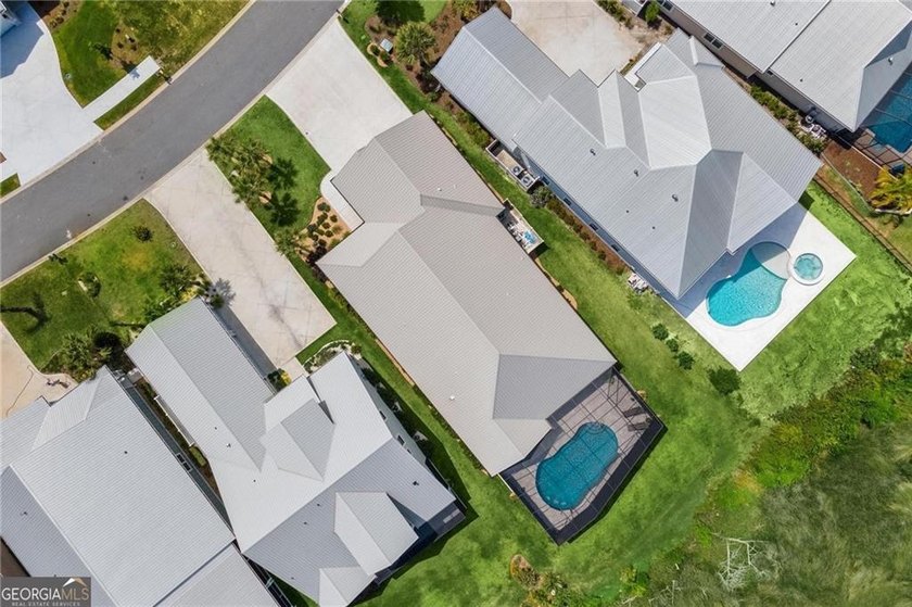 Welcome to a refined coastal sanctuary in the gated enclave of - photo 5