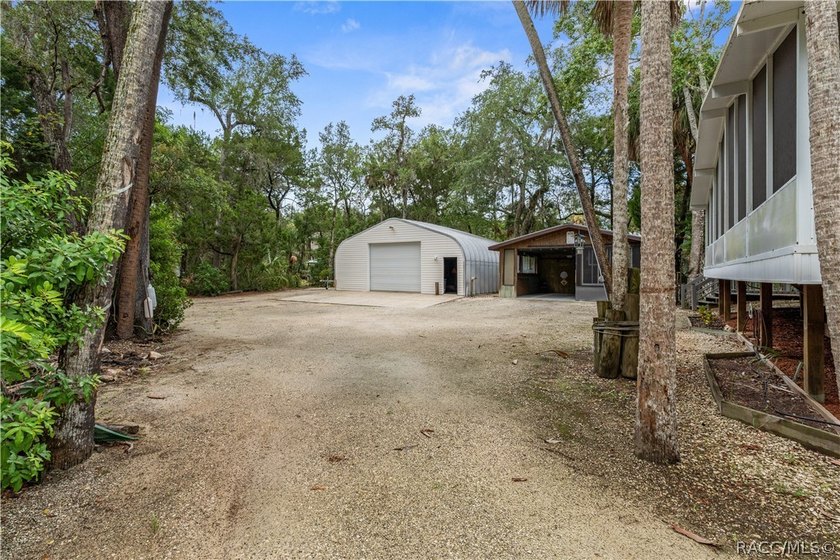 Tucked away on a beautiful wooded 1-acre waterfront lot in the - photo 31