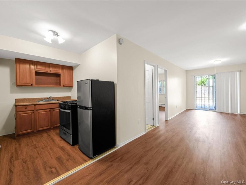 This three-story brick two-family home in Cypress Hills features - photo 14