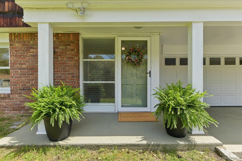Set on a full acre and surrounded by mature trees and lush - photo 2