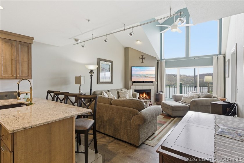 Top-floor condo with soaring vaulted ceilings and dramatic - photo 16