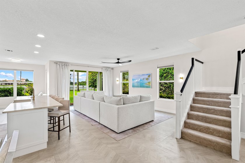 Set on a beautifully landscaped parcel, the covered loggia opens - photo 12