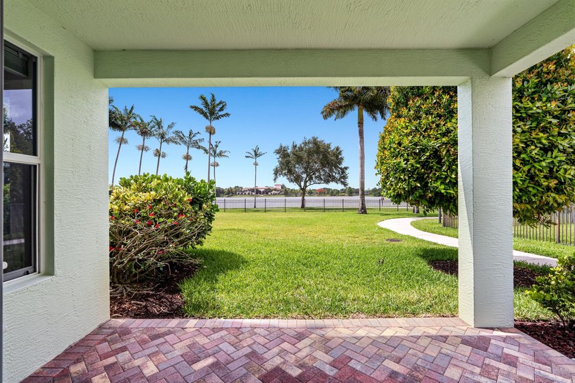 Set on a beautifully landscaped parcel, the covered loggia opens - photo 27