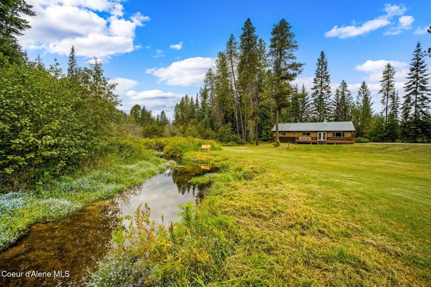 This serene 1.25 acre property on Lamb Creek offers 200 ft. of - photo 2