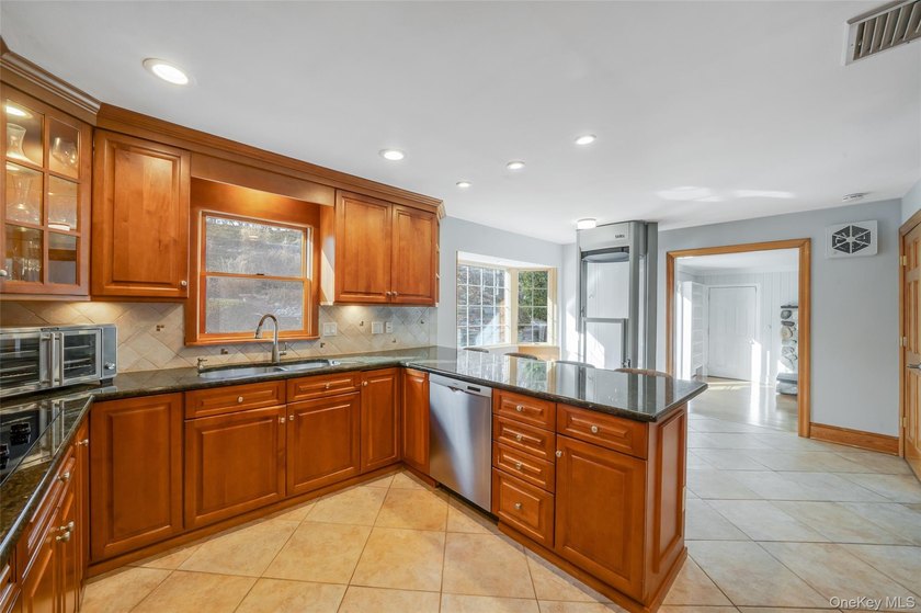 Set within the serene landscape of Rolling Woods in Riverhead - photo 14