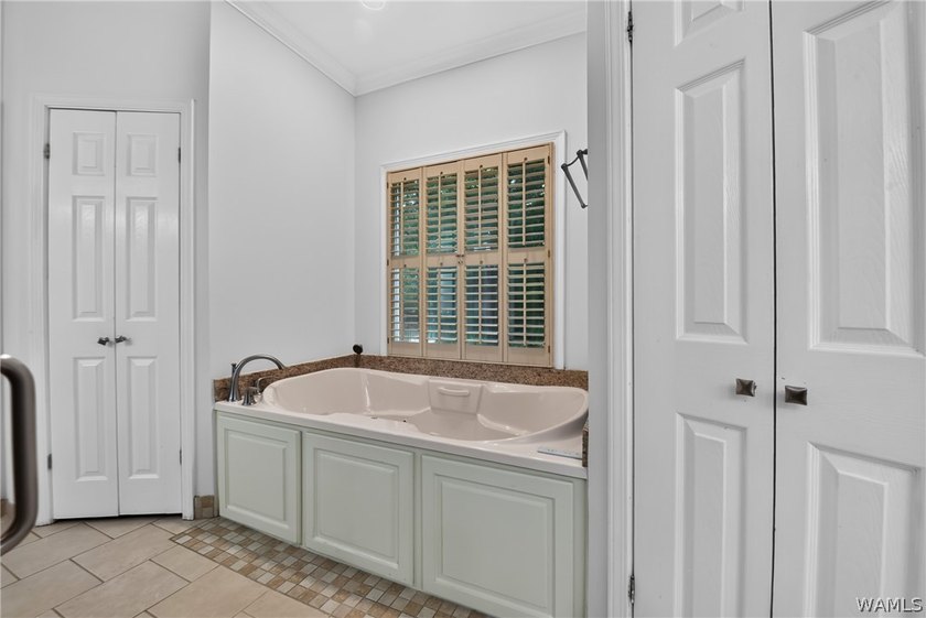Nestled on a wooded golf course lot in the sought-after - photo 32