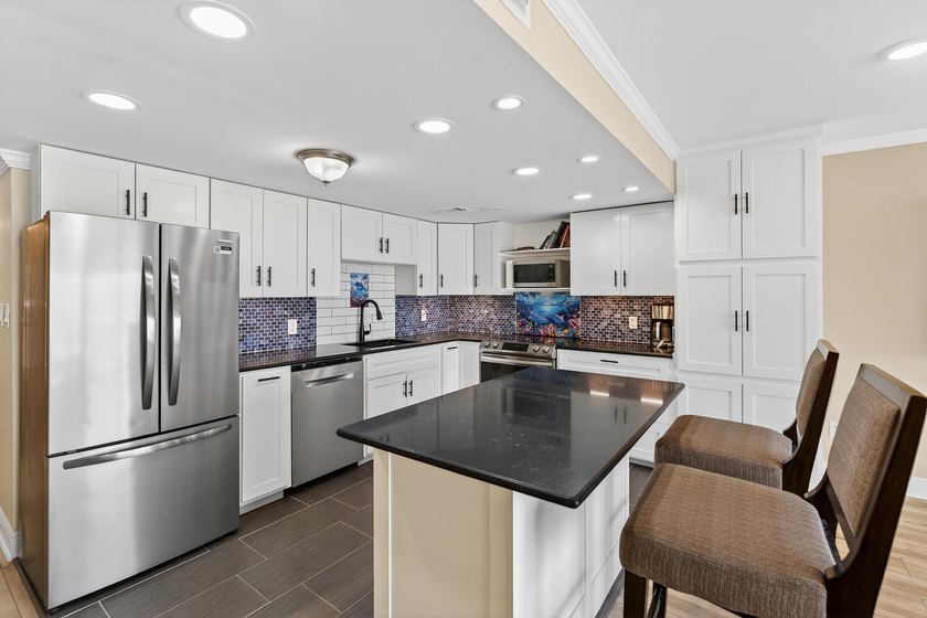 Rare opportunity to own a 3rd-floor end unit in the gated - photo 11