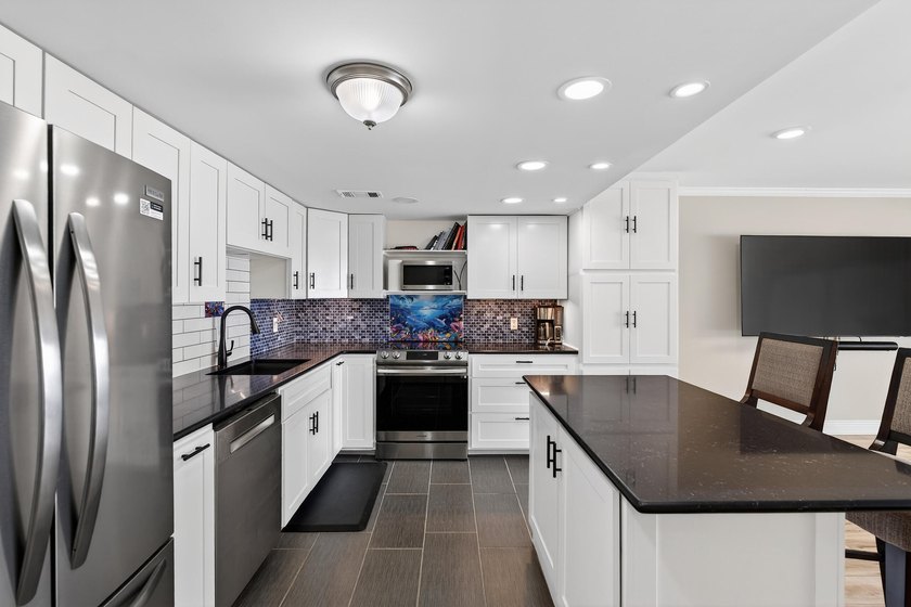 Rare opportunity to own a 3rd-floor end unit in the gated - photo 16