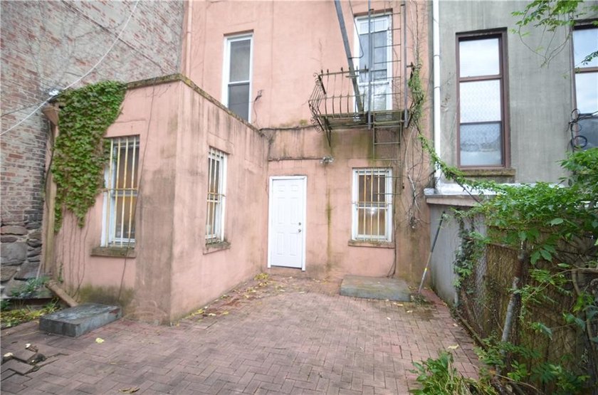 Welcome to this charming three-family brownstone, ideally - photo 21