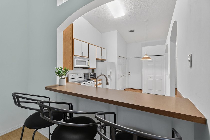 A MUST-See! This charming NEW 2025 ROOF and lakefront villa is - photo 17