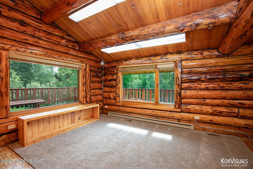 Experience the warmth and character of log home living in this - photo 8
