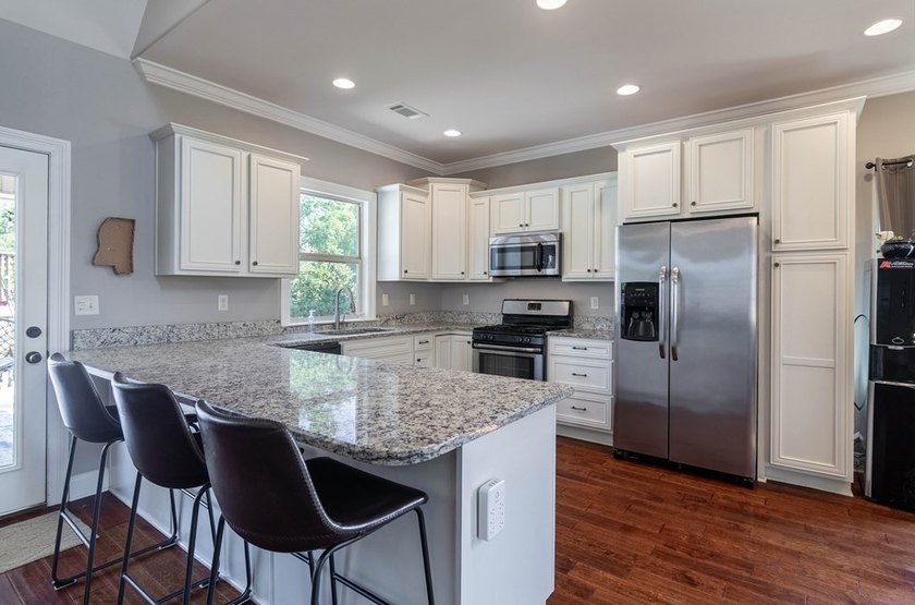 Tucked into The Lakes subdivision on 1.9 acres that includes - photo 2