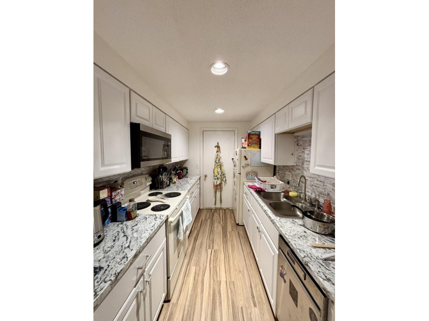 Enjoy the ease of low-maintenance living in the desirable - photo 3