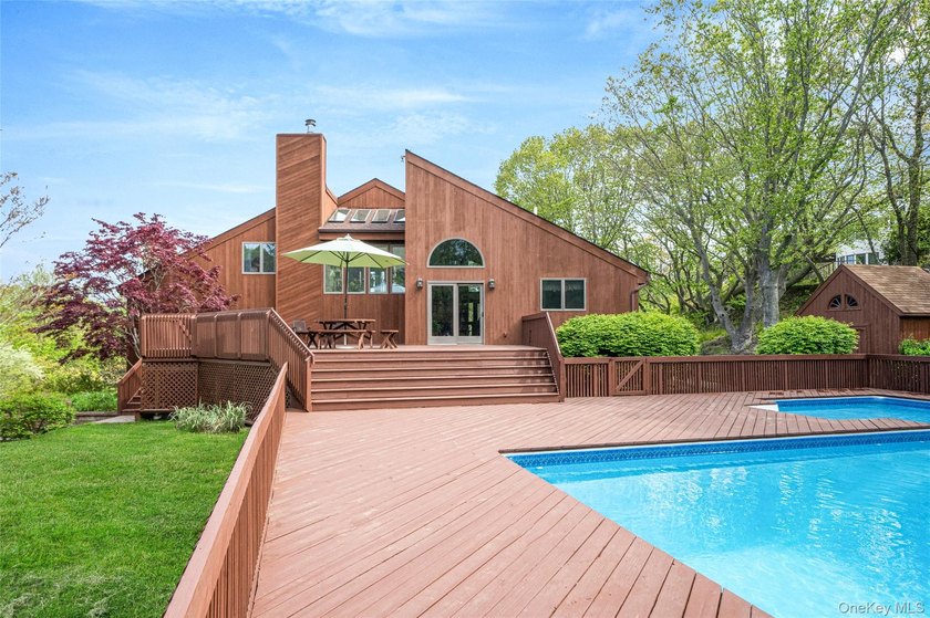 Set within the quiet Rolling Woods neighborhood on a shy acre at - photo 14